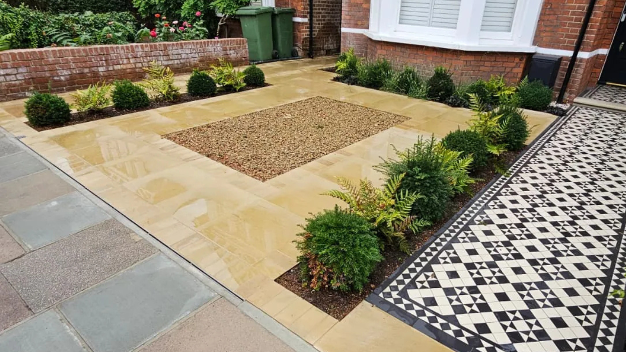 Patterned tiled entrance path beside a paved driveway